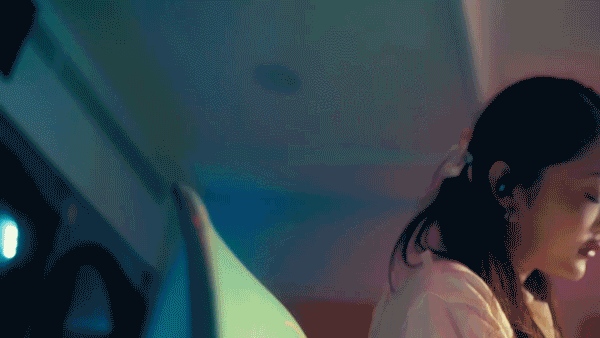 Woman listening to music with ROG earbuds