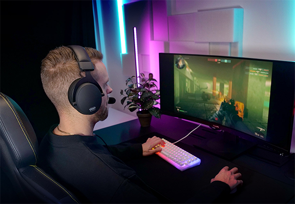 Gamer sat next to PC wearing H2 headset so showcase its design