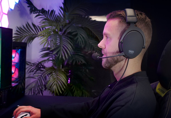 Gamer sat next to PC wearing H2 headset so showcase its design