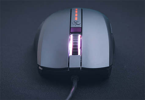 Top frontal view of the mouse on a black mousemat with RGB turned on