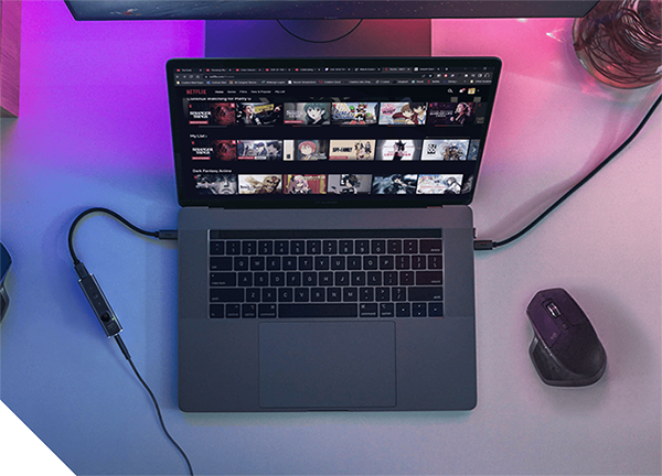 Sound Blaster X1 linked between headphone cable and laptop