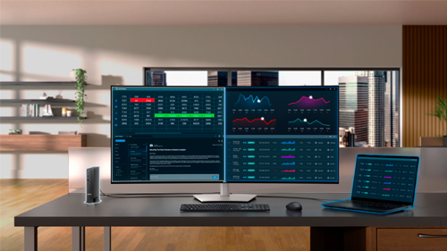 Image of the monitor on a desk connected to a laptop and a PC