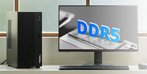 Photo of the mini PC on a desk next to a monitor