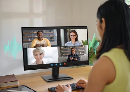 Lifestyle image of a woman on a group call using the monitor