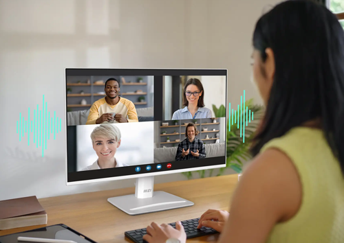 Lifestyle image of a woman on a group call using the monitor
