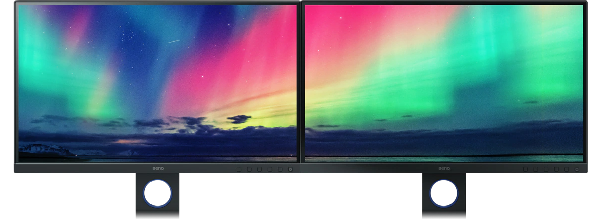 two BenQ SW321C Monitors side by side with consistent colour across the image of northen lights across both