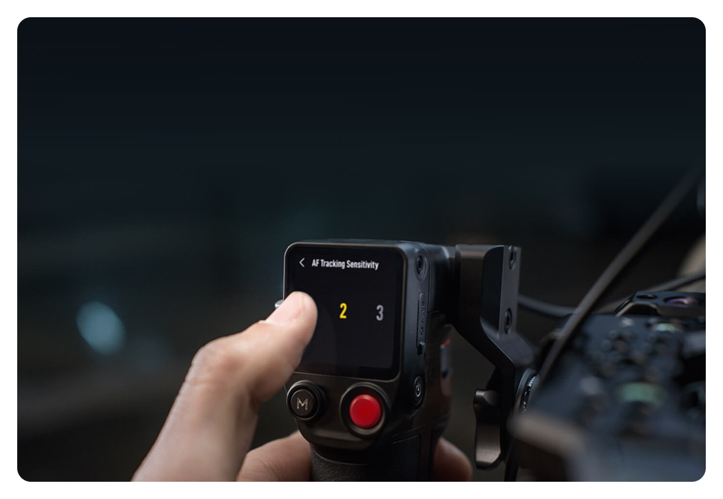 someone using the dji focus pro grip touchscreen