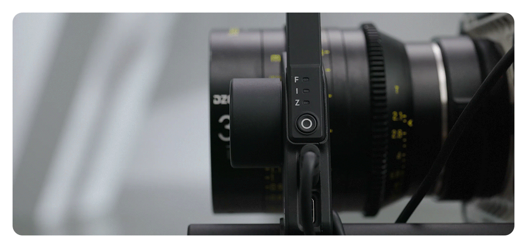 someone using the dji focus pro grip to make focus adjustments