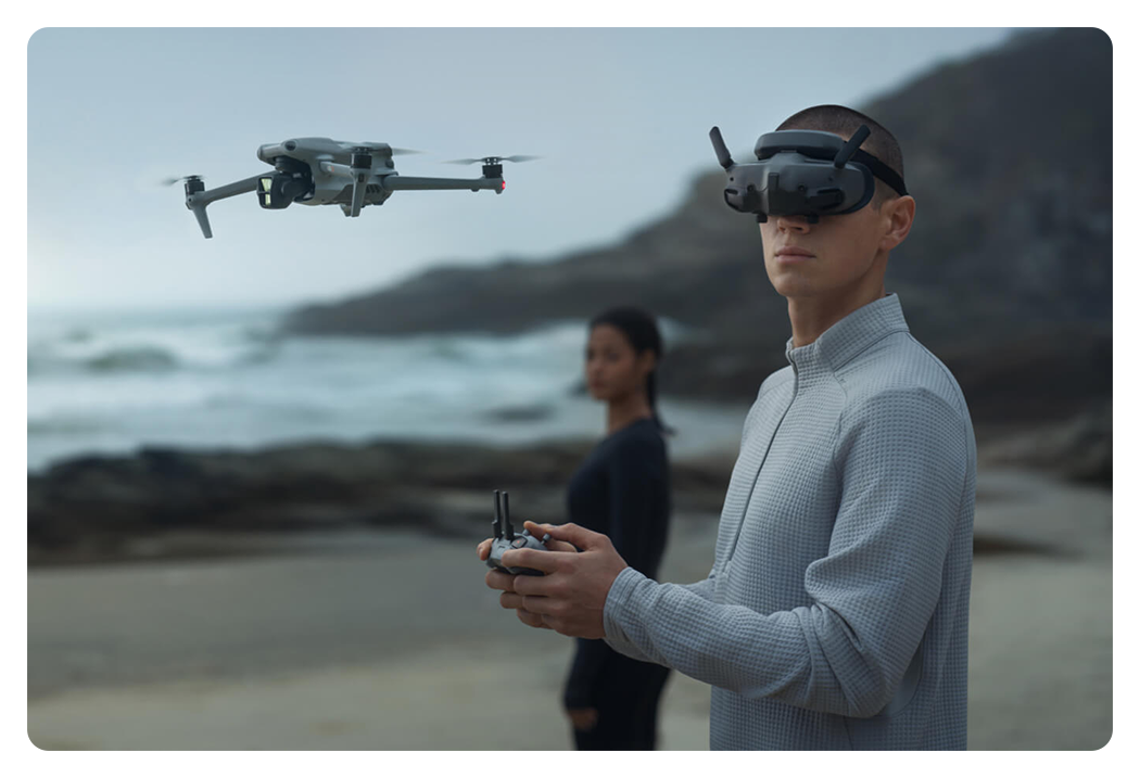 someone flying a drone with the dji goggles 3 on a beach
