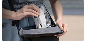 someone putting the dji mini 3 into a camera bag