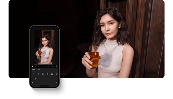 Photo of an asian woman infront of a dark wooden door holding a glass of tea