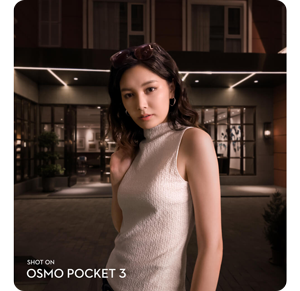 asian woman wearing cream coloured dress stood infront of modern home shot on DJI osmo pocket 3