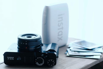 Fujifilm X-E5 and Instax Mini Printer on wooden desk