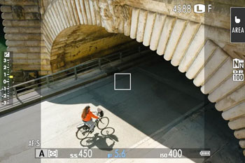 Sample image of cyclist riding under sandstone bridge