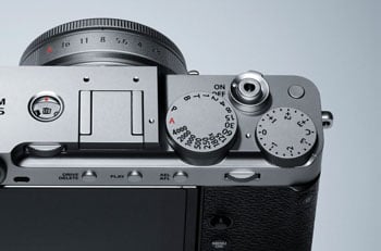 Close up photograph of Silver Fujifilm X-E5 top plate and shutter speed dial