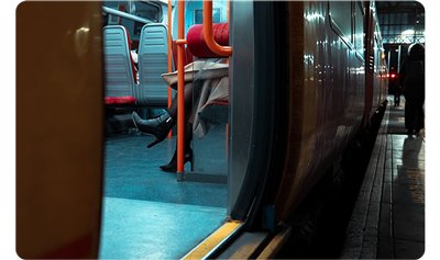 X100VI sample image of womans feet and legs sat on train looking through the doors