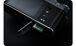 Fujifilm X100VI with SD card door open with memory card inserted