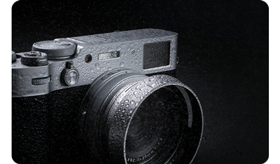 Fujifilm X100VI sprayed with water droplets on black background
