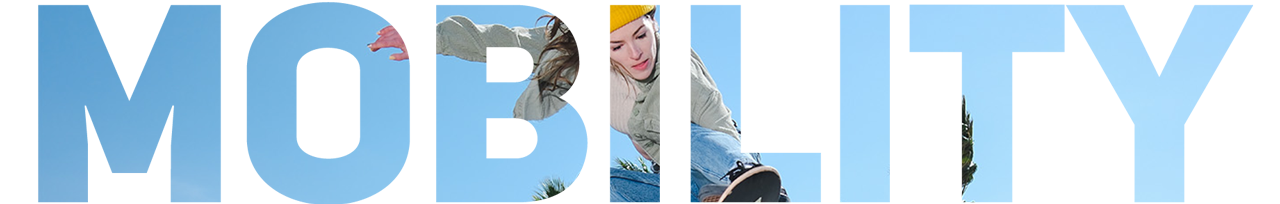 Female skateboarder completing a grab trick with a blue sky backdrop inlayed into the word mobility