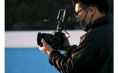 Filmmaker using Fuji XH2S with built out rig and Atomos Monitor
