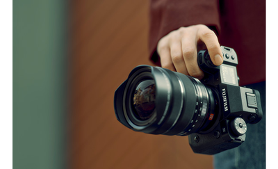 Fujifilm X-H2S held vertically by photographer pressing the shutter button