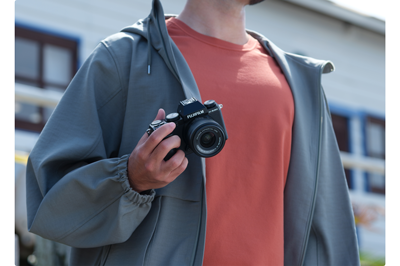 someone holding the fuji xs20 in one hand showing the compact body