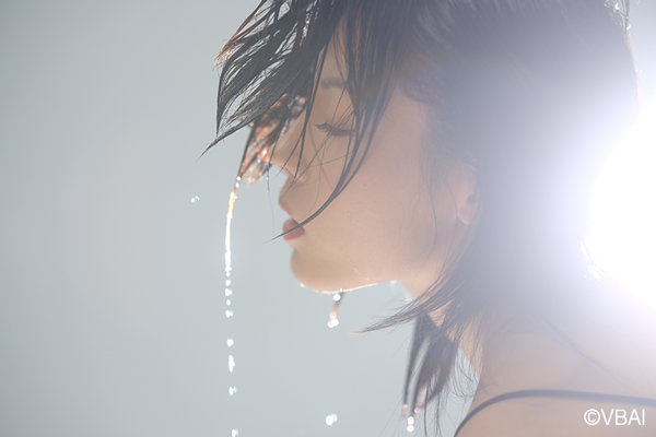 Fujifilm XT5 astia Film Simulation sample image of an asian woman flipping her wet hair upwards with water droplets falling
