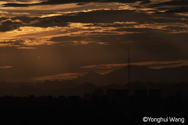 Fujifilm XT5 Eterna Film Simulation sample image golden hour skyline photograph of a city with mountain ranges in the distance