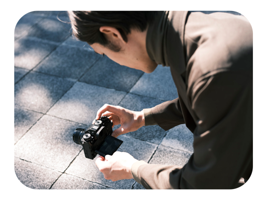 A photographer kneeling capturing a low-angle shot using fuji xt5 camera