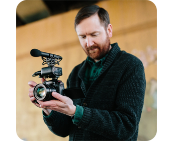 a man filming using the panasonic lumix gh5m2 mirrorless camera