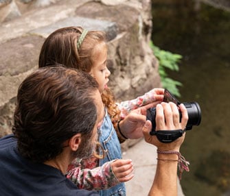 Father and Daughter recording video with Panasonic HC-V900 camcorder