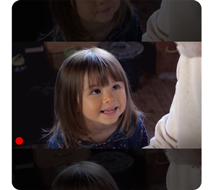 photograph of young girl looking up at parent