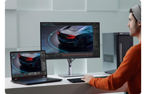 photograph of graphic artist working on ASUS ProArt display and laptop