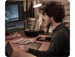 Filmmaker/Video Editor editing videos at a desk with ASUS ProArt PA32DC Profesional Monitor