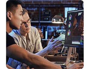 two colourists reviewing a colour grade on a ASUS ProArt PA32DC Monitor