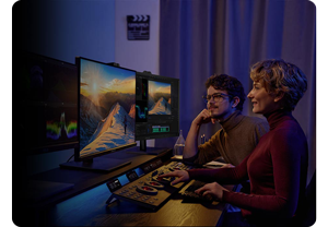 Two video editors reviewing footage on ASUS ProArt PA32DC