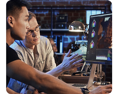 two colourist reviewing a colour grade on a proart display