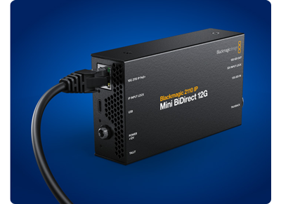 IMage of Blackmagic 2110 IP mini BiDirect 12G converter with ethernet cable running out on blue background
