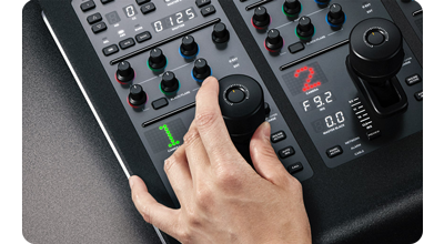 Person operating camera one control joystick on blackmagic ATEM advanced panel