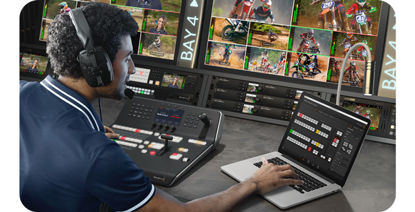Man operating in live production control room with blackmagic ATEM Production Switchers and Controls using ATEM software on Apple Macbook