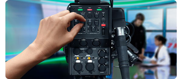 operator using the controls on the blackmagic camera fiber converter