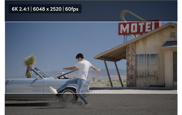 6K 2.4:1 still of a man kicking dust in front of a car in a motel parking lot