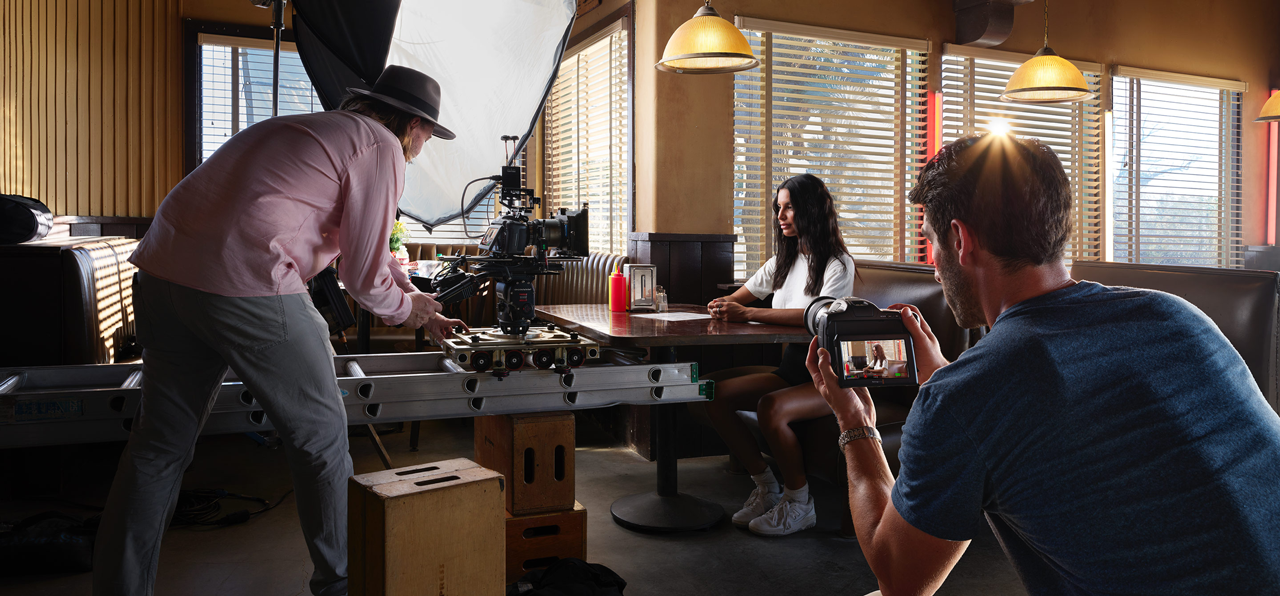 Full film production scene setup with a dolly, lighting rig and multiple cinema camera 6k operators