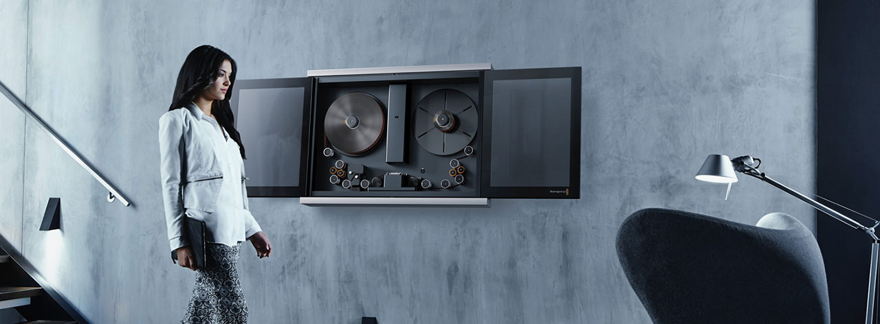 image of woman walking past Cintel G3 HDR Scanner mounted to a grey wall