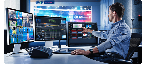 Broadcast producer adjusting video feeds with Blackmagic VideoHub