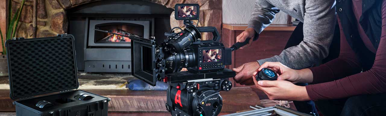Camera operators using PYXIS 12K camera on film set in front of fireplace