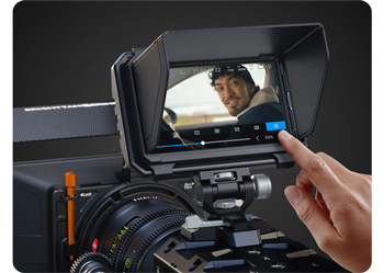 image of person using touchscreen control on PYXIS Monitor mounted to camera