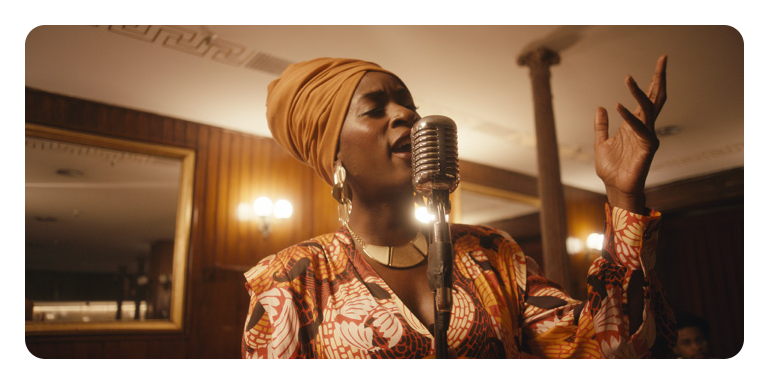 colour accurate example of footage on the blackmagic smartview 4k of a woman singing into a microphone
