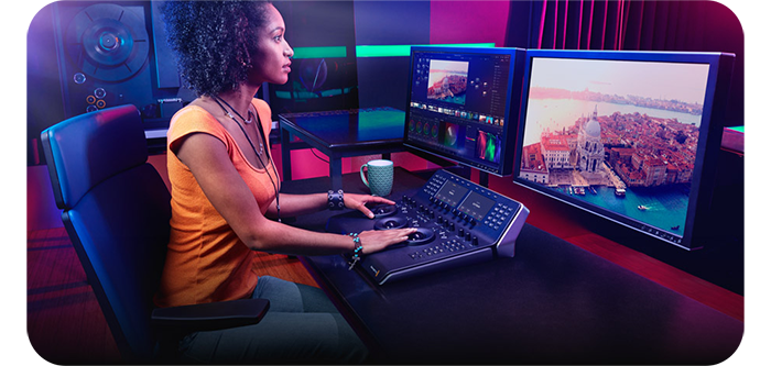 someone at a desk using blackmagic davinci resolve studio