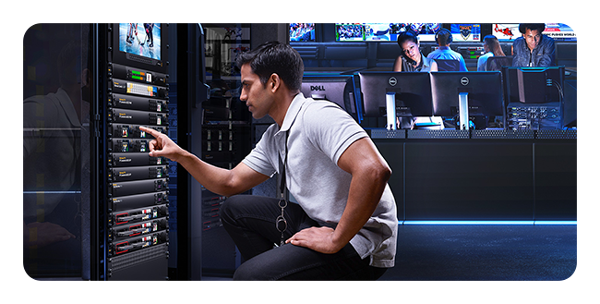 someone looking at a rack mounted Blackmagic 2110 IP converter in a control room